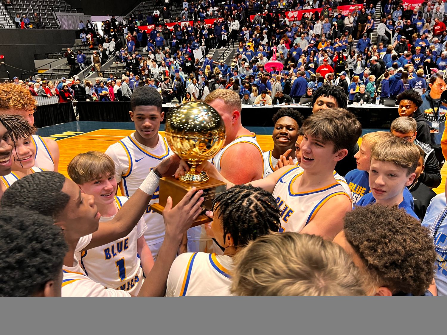 The Booneville Blue Devils celebrate a third-straight championship by hoisting the golden ball on Friday, March 1 at the Mississippi Coliseum in Jackson, Miss.
